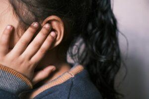 girl covering ear